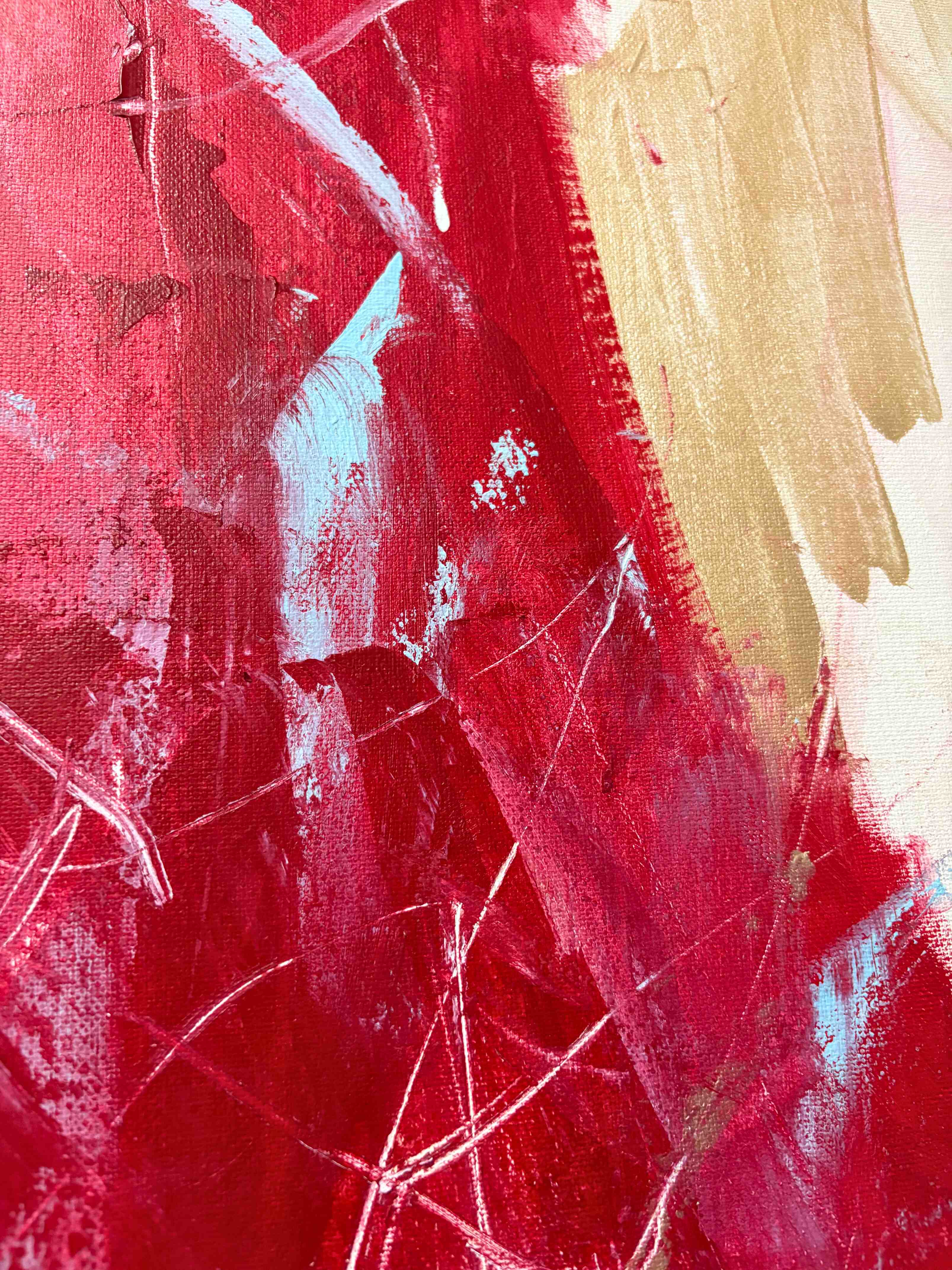 Close-up detail of Sadie Mae's abstract painting showing crimson, gold and teal brushwork on canvas